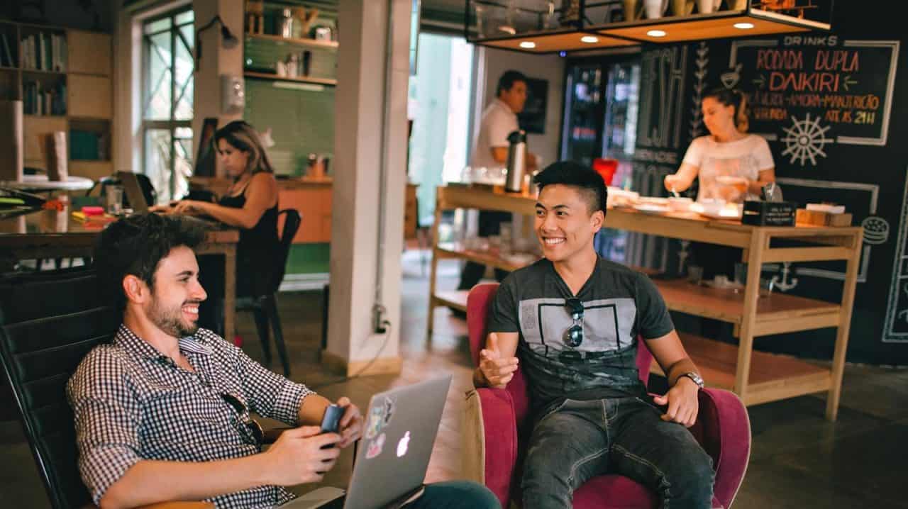 Photograph of Men Having Conversation Seating on Chair